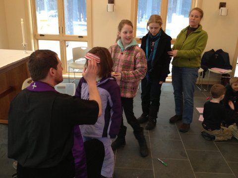 The children receive ashes on Ash Wednesday